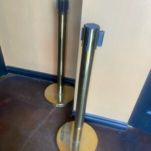 Stanchions - gold colored with red retractable ribbon - crowd control