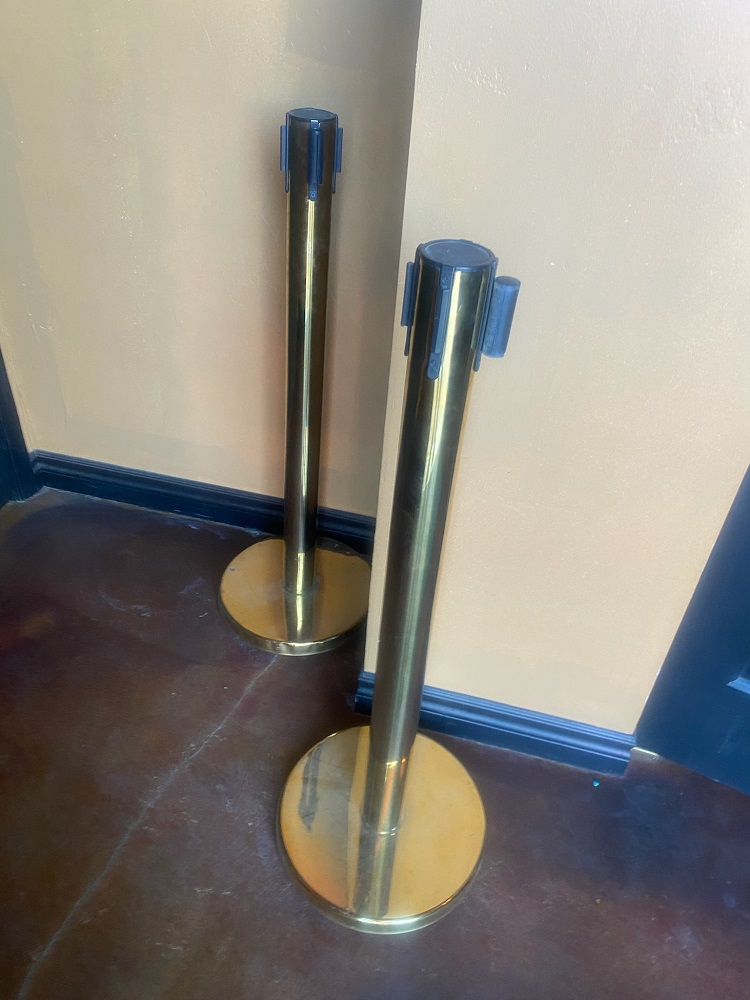 Stanchions - gold colored with red retractable ribbon - crowd control