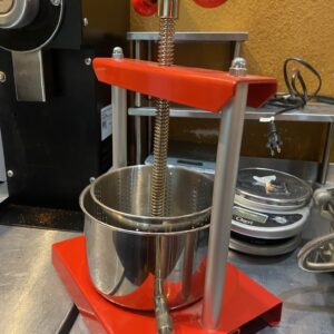 Smaller red twist-top tincture and juice press