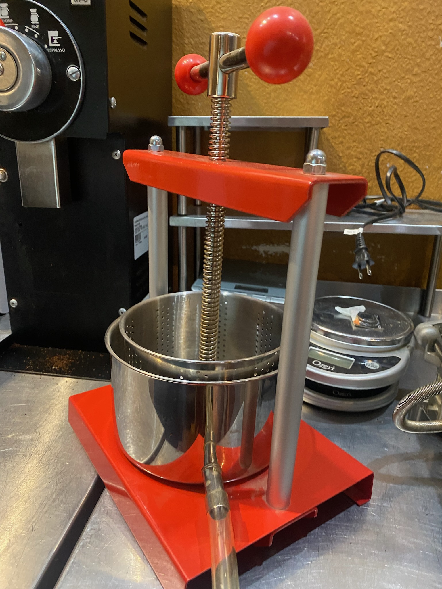 Smaller red twist-top tincture and juice press